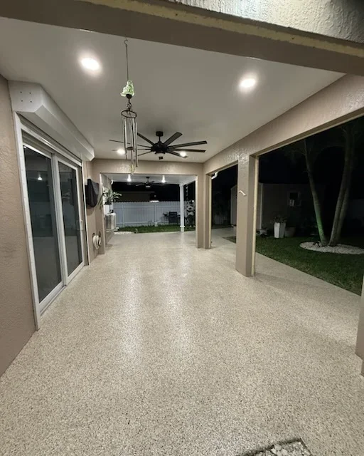 Epoxy-coated patio floor with recessed lighting and ceiling fan
