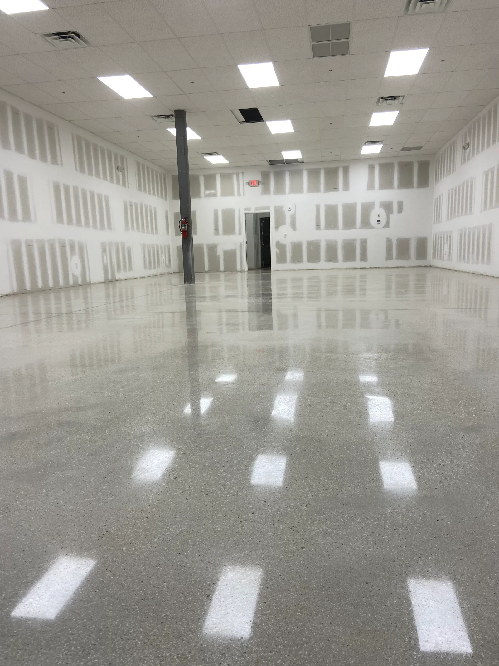 Polished epoxy flooring with high-gloss finish in commercial space with LED lighting