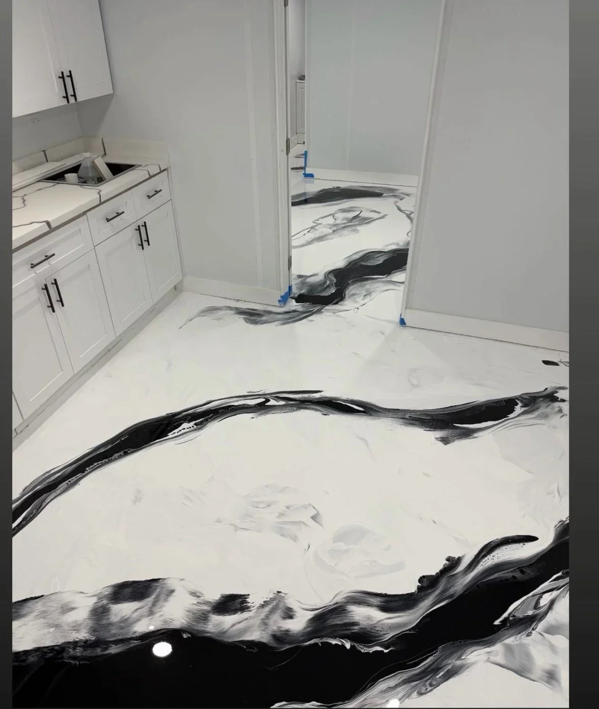 White and black swirled epoxy resin bathroom floor with seamless finish