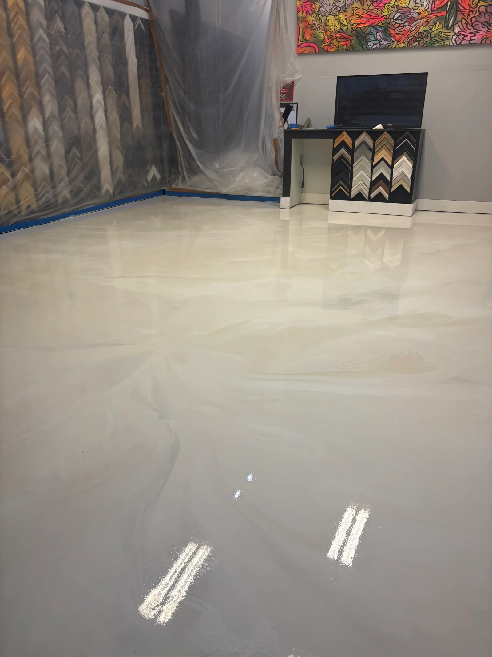 Freshly applied light gray epoxy floor with high-gloss finish in commercial space