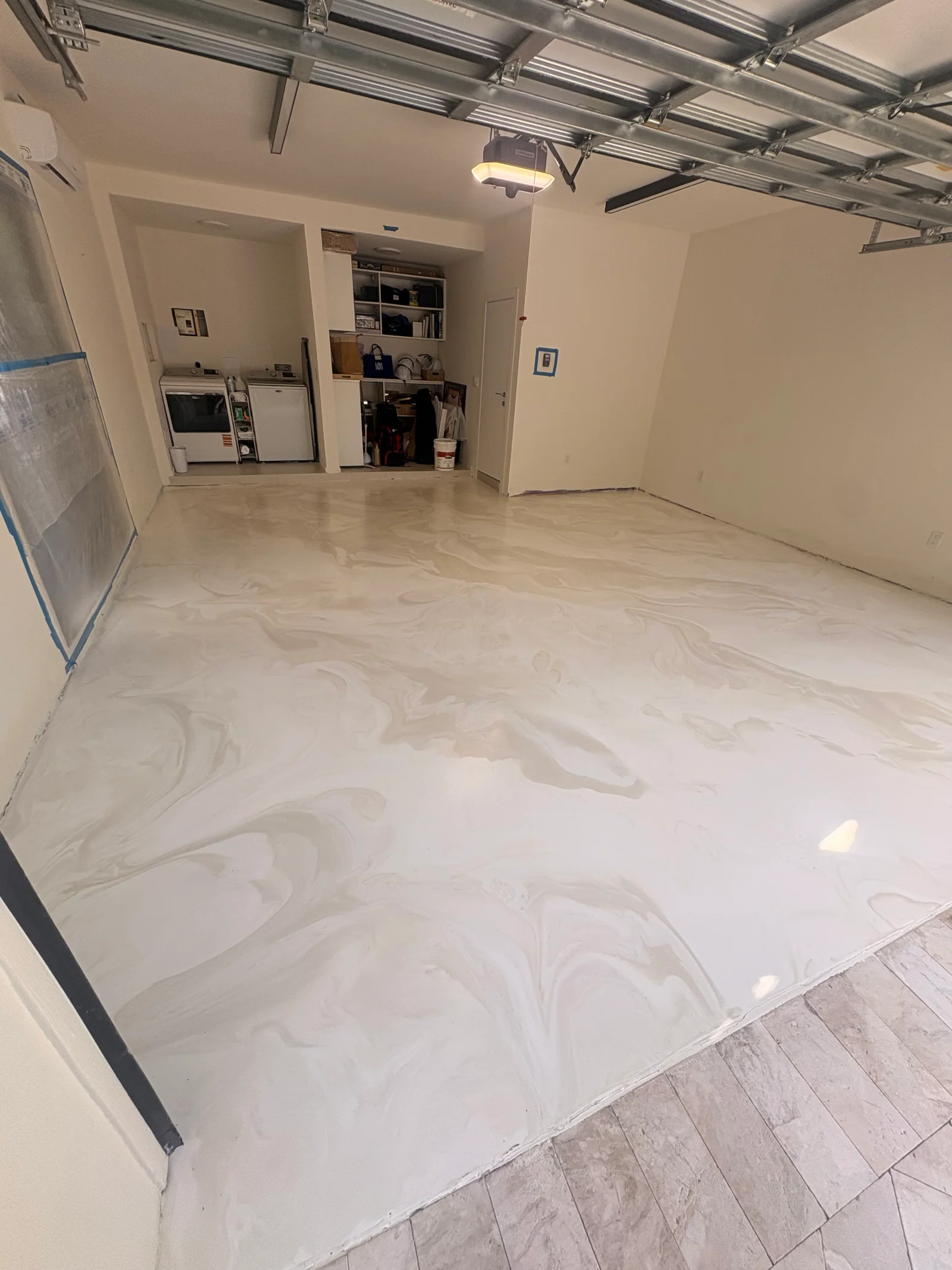 Light gray epoxy garage floor with marble effect finish and clean edges