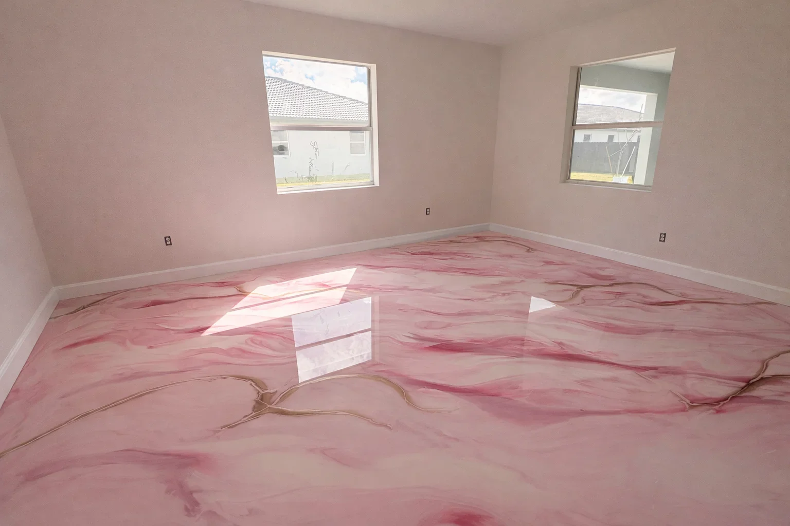 Pink marble-effect epoxy resin floor with burgundy veining in residential room with windows